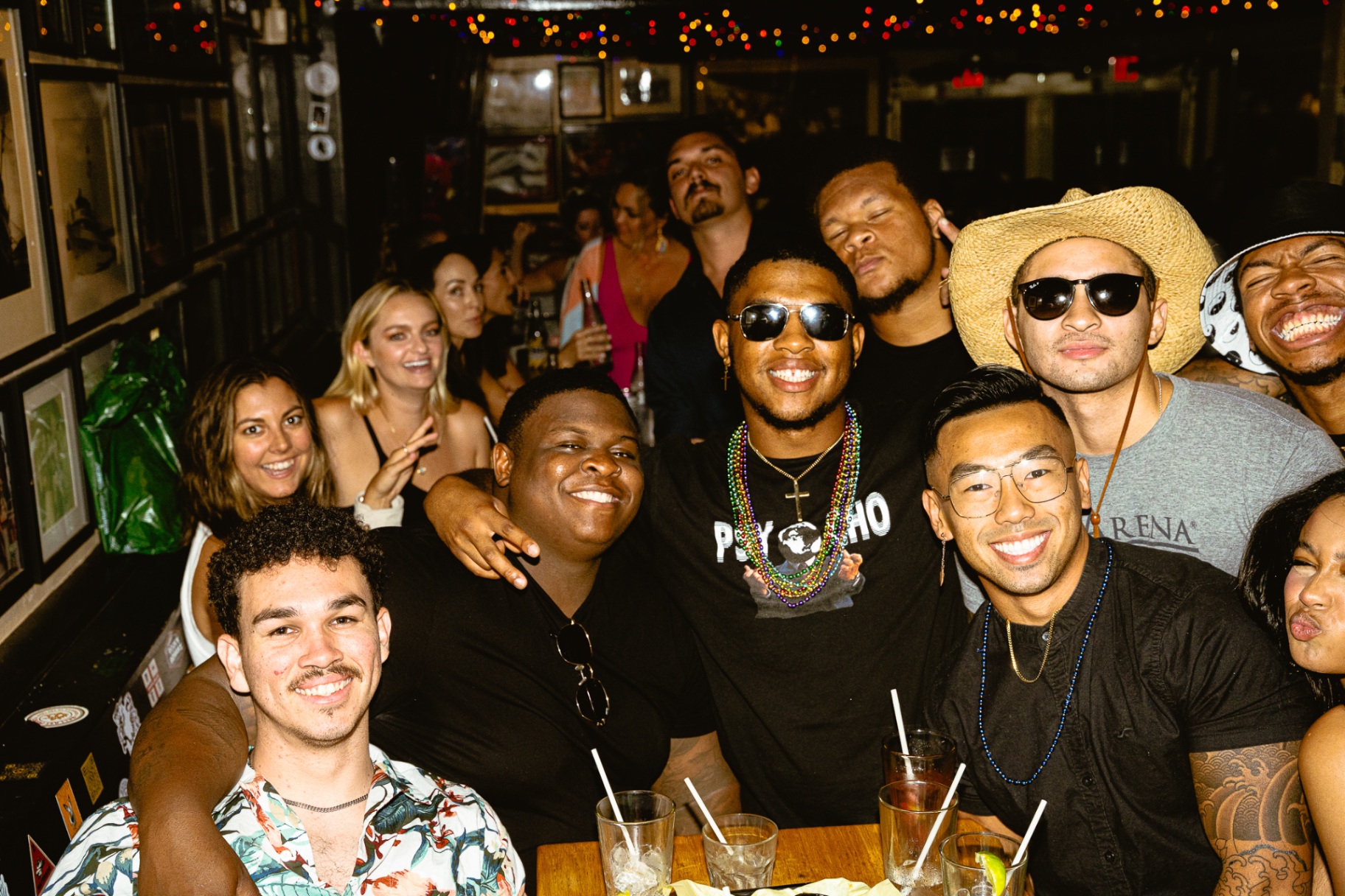 A packed table of friends sharing drinks at Waterfront Bar & Grill in Little Italy